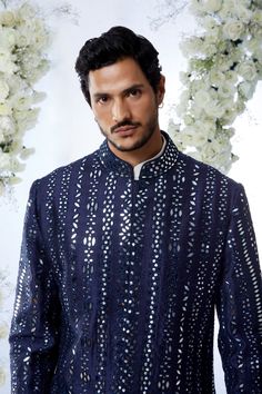 This midnight sherwani set features all over mirror work on a raw silk base. It is paired with an off-white cotton kurta and a afghani cotton silk salwar. Completing footwear is also available.From Seema Gujral's Tuscan Summer collection. DELIVERY TIMEPlease allow 4 months for your outfit to arrive.FABRIC DETAILSRaw SilkProfessional cleaning only. Designer Ceremonial Kurta With Mirror Work, Designer Nehru Jacket With Mirror Work For Festive Season, Designer Nehru Jacket With Mirror Work For Eid, Designer Nehru Jacket With Mirror Work For Festivals, Designer Kurta With Mirror Work For Festive Occasions, Designer Festive Kurta With Mirror Work, Bandhgala With Mirror Work For Diwali, Diwali Bandhgala With Mirror Work Straight Kurta, Designer Nehru Jacket With Mirror Work For Diwali