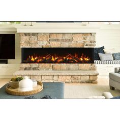 a living room with a stone fireplace and tv on the wall, in front of a couch