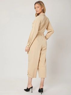 The Long Sleeve Belted Utility Jumpsuit is a stylish and practical piece of clothing suitable for various occasions. It features a plain design with a collar neckline, long sleeves, and regular sleeves. The jumpsuit has a high waistline and comes with a belt that cinches at the waist to create a flattering silhouette. The slight stretch in the fabric provides comfort and ease of movement. It is available in capris length, making it a perfect choice for both casual and formal events. Specificatio Comfy Jumpsuits, Utility Jumpsuit, Stretch Belt, Plain Design, Piece Of Clothing, Formal Event, Duster Coat, Capri, Types Of Sleeves