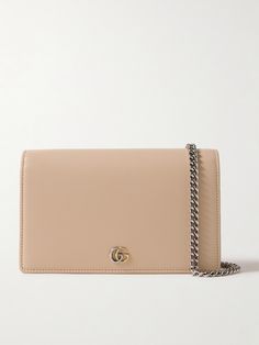 Gucci's wallet is sizable enough to use as a shoulder bag, too - simply attach the silver-tone chain strap and drape it cross-body. It's been made in Italy from sand leather and is punctuated with polished 'GG' hardware at the front. Store your phone, cardholder and lip gloss inside. Elegant Gucci Clutch Shoulder Bag, Elegant Leather Wallet On Chain Clutch, Elegant Leather Clutch Wallet On Chain, Modern Wallet On Chain For Formal Occasions, Modern Formal Wallet On Chain, Elegant Leather Wallet On Chain, Elegant Everyday Luxury Wallet On Chain Clutch, Classic Gucci Shoulder Bag With Chain Strap, Gucci Classic Shoulder Bag With Chain Strap