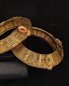 Simply a mark of royalty and elegance!! Handcrafted in brass with gold plating and fine quality Kundan stones. Set of 2 For wrist Size 2.4 Inner Diameter: 2.25 inches Not Openable The bangles are the same as shown in the pictures. We have only one piece in this color and design, hence you get what you see in the pictures. Gold-tone Metal Bangle For Wedding, Elegant Gold Jeweled Bangle, Elegant Jeweled Gold Bangle, Antique Gold Jeweled Jewelry For Weddings, Gold-tone Hallmarked Jewelry For Wedding, Gold Bracelets With Intricate Design For Marriage, Gold Bracelets With Detailed Design For Marriage, Gold Jeweled Brass Bracelet, Heavy Antique Gold Jewelry