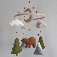 a mobile with animals and trees hanging from it's sides