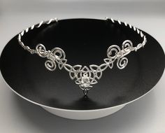 Celtic bridal headpieces and circlets are sure to make any Celtic bride to be happy! I have handmade this circlet in sterling silver featuring a blend of Trinity Knot designs in elegant symmetry and will set your choice of an 8mm faceted gemstone in the center. This will fit behind the ears and will come with a jeweler's elastic cord (which will be tied on one end) and you would tie the other side through for a snug and comfortable fit, without concern of it falling off in motion. Please convo f Handmade Round Crown Wedding Headpieces, Handmade Wedding Headpieces With Round Crown, Handmade Crown Headpiece For Wedding, Handmade Adjustable Headband For Weddings, Handmade Teardrop Crown Headpiece For Weddings, Handmade Wedding Jewelry Headband, Handmade Adjustable Headpieces For Wedding, Adjustable Handmade Headpieces For Wedding, Celtic Bride