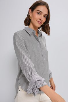 A cool-girl closet stapleA classic silhouette in a chic gray and white striped pattern, the Boyfriend Shirt from TWP is as classy as it gets. This top is made for a relaxed fit with a chest patch pocket, concealed front placket, and staple single roll button cuffs. Pair with everything from denim to maxi skirts for a positively chic look. Our Favorite Details: Long sleeves with button cuffs Concealed front button placket Front chest pocket Curved hem Relaxed fit Material: 100% CottonCare: Dry cl Chic Button-up Top With Vertical Stripes, Modern Tops With Striped Collar For Work, Modern Top With Striped Collar For Work, Vertical Stripes Button-up Top For Work, Workwear Shirt With Striped Collar And Shirttail Hem, Work Shirt With Striped Collar And Shirttail Hem, Casual Striped Blouse For Business Casual, Classic Pinstripe Tops With Relaxed Fit, Casual Shirt With Contrast Stripes For Work