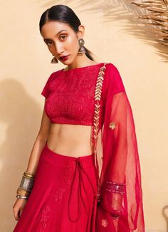 A red bohemian bridal lehenga with a silk blouse embroidered with moroccan detail with a handwoven silk circle lehenga, a red hand woven organza dupatta embroidered in tribal moroccan motifs in hammered gold All our blouses can be customised for sleeves, neck design and length. An additional Net Dupatta can be added from our Dupatta Collection Composition: Silk , Organza All products can be customised for sleeves, length of blouse and neck design Delivery : 6-8 weeks as the product is hand craft Bohemian Designer Choli With Sheer Dupatta, Bohemian Pre-draped Saree With Sheer Dupatta For Designer Wear, Bohemian Blouse Piece With Sheer Dupatta For Festive Occasions, Bohemian Wedding Pre-draped Chanderi Saree, Red Blouse Piece With Sheer Dupatta For Transitional Season, Bohemian Pre-draped Saree With Resham Embroidery, Red Pre-draped Saree For Wedding And Transitional Seasons, Bohemian Blouse Piece With Sheer Dupatta For Diwali, Transitional Red Lehenga With Sheer Dupatta