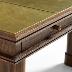 a close up of a wooden table with a drawer on it's left side