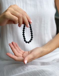 This obsidian beaded bracelet is the perfect way to add a touch of natural magic to your look. The black beads are said to contain powerful healing energy and are thought to bring good luck and protection against negative forces.

This Black obsidian bracelet is the perfect way to access the power of the universe. Made with natural obsidian stones, this bracelet is a powerful tool for better health, peace of mind, and spiritual growth. Black Gemstone Beads Rosary Bracelet Gift, Black Rosary Bracelet With Gemstone Beads As Gift, Spiritual Black Beaded Bracelets As Gift, Black Spiritual Beaded Bracelets As Gift, Black Healing Beaded Bracelets With Round Beads, Black Beaded Bracelets For Healing With 8mm Beads, Spiritual Hand-strung Black Bracelets, Spiritual Black Hand-strung Bracelets, Black Beaded Bracelet With 108 Beads For Meditation