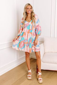 - We are obsessed with this vibrant dress! - Unlined material with a colorful print - A v-cut neckline - Short sleeves with elastic shoulders and elastic cuffs - Hidden side pockets - A square cut back with a smocked detail - A flowy yet flattering silhouette that ends in a flirty mini dress length hemline Measurements S : Bust 32", Hip 42", Length 28.5", Sleeve Length 16.5", Waist 34". M : Bust 34", Hip 44", Length 28.5", Sleeve Length 17.5", Waist 36". L : Bust 36", Hip 46", Length 29", Sleeve Kids Athleisure, Fall Style Guide, Vibrant Dress, Babydoll Mini Dress, Swimwear Dress, Little White Dresses, Square Cut, White Wedding Dresses, V Cut