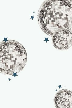 three shiny disco balls with stars flying around them