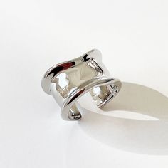 Experience the Modernism Concave Silver Ring Wide Band - a striking and lighthearted accessory that doesn't take itself too seriously! This charming and edgy design will add a touch of playfulness to any ensemble. Don't pass up on this silver band that is guaranteed to catch eyes. Band width: approx. 15mm Size: US7, open ring and slightly adjustable S925 silver To complete the look, check out our Modernism Concave Stud Earrings with gold and silver options available. Modern Silver Midi Rings, Modern Silver Metal Midi Rings, White Gold Metal Open Midi Rings, White Gold Open Midi Rings, Trendy Nickel-free Sterling Silver Rings, Trendy Nickel-free Open Ring, Modern Nickel-free Open Midi Rings, Modern Silver Midi Rings For Promise, Modern Silver Midi Rings For Gift