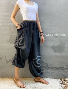 The harem style trousers made from cotton fabric 100%with an elasticated smock waist and ankles they provide a comfortable lightweight fit, perfect for casual wear, festivals, yoga, holidays as well as pairing with a plain top to get that popular look.   Materials: Cotton Sizing: One size fits most. Size : (inches) ✿Waist : 22-42 inch ( 55-106 cm ) ✿ Hip :up to 49 inch ( 124 cm) ✿ Length 39" ( 100 cm ) ✿2 sides pockets S I Z E : US SIZE 4 - 12 , UK SIZE 8 - 16 , EU SIZE 36 - 44 MODEL SIZE : size Black Baggy Ankle-length Harem Pants, Bohemian Black Harem Pants With Elastic Waistband, Summer Harem Parachute Pants With Elastic Waistband, Casual Relaxed Fit Harem Pants For Festivals, Black Bohemian Relaxed Fit Harem Pants, Black Bohemian Harem Pants With Relaxed Fit, Black Bohemian Harem Pants Ankle-length, Ankle-length Relaxed Fit Harem Pants, Black Hippie Pants For Spring