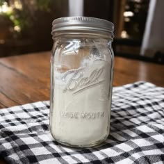 a mason jar sitting on top of a checkered table cloth