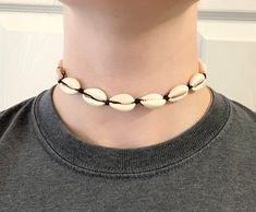 "This cowry shell choker is perfect for vacations and everyday wear. This choker is a summer statement piece. It's 14\" with an adjustable string that adjusts the choker to 27\". This choker has fresh water cowry shells and a black wax cord. It usually takes me 1-3 business days to make your order. Depending on where you live, it will take around 1-4 weeks to get your order shipped to you. Thanks in advance!" Adjustable White Cowrie Shell Choker, Summer Shell Choker As A Gift, Shell Choker As A Summer Gift, Trendy Adjustable Shell Necklace For Beach, Adjustable Shell Choker Gift, Adjustable Shell Choker For Gift, Adjustable Shell Choker For Festivals, Adjustable Shell Choker As Gift, Adjustable Shell Choker Perfect As A Gift