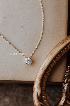 6 mm Round Moissanite Diamond Necklace, Bezel Solitaire Necklace, Layered Necklace, Dainty Necklace, Gold necklace Bridesmaid Gift, Diamond Pendant, Engagement Gift For Fiancée , Diamond Pendant For Gorgeous Gift, Solitaire Women's Pendant, Gift For Friendship Day ✦ STONE DETAIL ✦ ✧ Stone Shape : Round ✧ Stone Size : 6mm ✧ Stone Weight : 0.80 Carat Approx ✧ Stone Color : D (Color less) ✧ Stone Clarity: VVS ✦ 𝐌𝐞𝐭𝐚𝐥 𝐃𝐞𝐭𝐚𝐢𝐥𝐬 ✦ ✧ Metal Type : 925 Silver, Yellow Gold , Rose Gold, White Go Formal Round Birthstone Necklace With Delicate Chain, Round Bezel Setting Diamond Necklace Gift, Round Diamond Necklace With Bezel Setting As Gift, Solitaire Pendant Necklace With Delicate Chain For Anniversary, Formal Solitaire Necklace With Delicate Chain And Round Pendant, Classic Solitaire Necklace With Delicate Chain, Cubic Zirconia Solitaire Necklace With Bezel Setting For Wedding, Wedding Cubic Zirconia Solitaire Necklace With Bezel Setting, Formal Solitaire Necklace With Delicate Chain And Round Cut