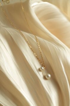 Elevate your style with the COCOKIM Embellished Series Double Bead Necklace. This exquisite piece features a unique design with two stunning beads suspended delicately from a sleek chain, creating an elegant and versatile look. Whether you're dressing up for a special occasion or adding a touch of sophistication to your everyday ensemble, this necklace is the perfect accessory. Metal: 14k Gold Filled Pearl: Freshwater Pearls Length: 450mm(Includes sliding extension chain) Main Pearl Dimensions: 7mm Pendant Length: 20mm Elegant Drop Necklace With Pearl Chain, Chic Beaded Chain Jewelry For Formal Occasions, Chic Formal Beaded Chain Jewelry, Elegant Beaded Chain Jewelry For Gifts, Elegant Beaded Chain Necklace, Elegant Gold Plated Dangle Necklace, Elegant Drop Necklace With Pearl Charm, Elegant Dangle Pearl Necklace With Pendant, Elegant Pearl Necklace With Beaded Chain As Gift