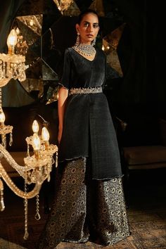 Black asymmetric top with pleated detailing. Paired with floral brocade woven ghaghra and velvet zardozi embroidered belt. - Aza Fashions Elegant Evening Sets For Diwali, Traditional Raw Silk Evening Set, Elegant Traditional Wear For Evening Eid, Elegant Traditional Wear For Eid Evening, Elegant Evening Traditional Wear For Eid, Embellished Brocade Sets With Traditional Drape, Elegant Evening Sharara For Festive Occasions, Elegant Festive Sharara For Evening, Evening Palazzo Set With Sheer Dupatta And Traditional Drape