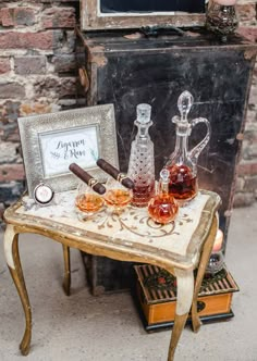 a small table with some glasses and bottles on it