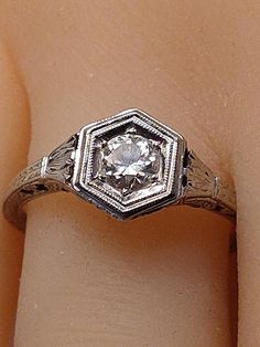 "This vintage ring is a winner in every respect. A beautiful Antique Engagement Ring circa 1900s. Art Deco 18k white gold marked. You can see it in the pic. Very faint from wear but it is there. The diamond is estimated and judged to be between .45 and .48 total carat weight. SI clarity, H/I color range. European cut diamond, Near colorless. Very sparkling and beautifully faceted. Tested and confirmed by my local jeweler who is in business over 30 years. Beaded 6 sided framework surrounds the so Vintage Platinum Ring For Formal Occasions, White Gold Ring For Vintage Events, Heirloom Brilliant Cut Diamond Ring Collectible, Vintage Hallmarked Engraved Ring For Formal Occasions, Vintage Rings With Intricate Design, 14k White Gold Victorian Ring For Anniversary, Collectible Round Diamond Ring With Intricate Design, Vintage Hallmarked Diamond Ring For Formal Events, Antique 14k White Gold Jewelry