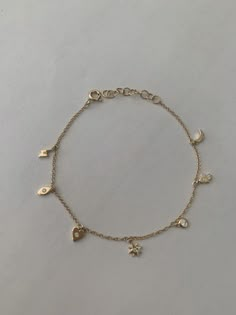 "This dainty yet sturdy charming charm bracelet is the perfect bracelet to layer with other bracelets or just to wear by itself. * 14K Yellow Gold * Approx. Diamond Weight: 0.07cts * Adjustable length: 6\"-7\" *Necklace also available: https://www.etsy.com/listing/510314824/14k-gold-tiny-charm-necklace Upgrades for FedEx/UPS guaranteed 2-day delivery are available and can be selected prior to checkout without separate invoicing. It is generally not an issue, but the USPS cannot guarantee deliver Minimal Charm Bracelet, Bracelet Charms Gold, Cute Everyday Bracelets, Bracelet Dainty, Charm Bracelet Dainty, Gold Bracelet With Charms, Gold Charms For Bracelets, Aesthetic Gold Bracelets, Gold Dainty Charm Bracelet