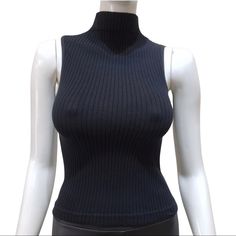 Black Rib-Knit Sleeveless Top With Mock Neck. Fabric55% Cotton 40% Nylon 5% Spandex One Size Stretch Ribbed Sleeveless Vest, Fitted Ribbed Sweater Vest For Layering, Black High Neck Tank Top For Layering, Fitted Ribbed Vest For Layering, High Stretch Ribbed Sleeveless Top, Black Turtleneck Tank Top For Fall, Chic Black Turtleneck Tank Top, Fitted Ribbed High Neck Sweater Vest, Fitted Ribbed High-neck Sweater Vest