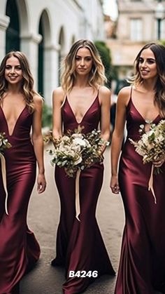 bridesmaids in maroon dresses walking down the street with bouquets on their laps