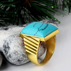 Metal: 14k Yellow Gold Turquoise*: 1.3cm x 1.8cm (0.5" x 0.7") shape - Rectangular cabochon setting type - Bezel setting *stone may vary in tone or pattern. Please allow for these natural variations. Product weight: 7.0 gr The versatile ring, that captivates with a stunning style! Created from 14k yellow gold, this ring boasts a massive blue turquoise gemstone on the top. Show this one off because it's too special to hide! See More Categories Browse Gold Turquoise Rings Browse 14K Gold Rings Bro Yellow Gold Turquoise Ring With Polished Finish, Polished Turquoise Ring For Gift, Polished Turquoise Ring As Gift, Modern Turquoise Ring With Polished Finish, Modern Turquoise Anniversary Ring, Gold Turquoise Ring With Large Stone As Gift, Elegant Turquoise Gemstone Signet Ring, Modern Blue Turquoise Gemstone Ring, Modern Turquoise Ring For Gift