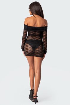 the back view of a woman wearing a black lace bodysuit with long sleeves and thigh high