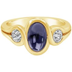 A appealing gemstone fashion ring showcasing a 2.50 carat oval shape blue sapphire cabochon in the center and an old european cut diamond on each side weighing 0.80 carats total. Set in an integrated bezel, Made in 18K Yellow Gold, Size 7.5 US Style available in different price ranges. Prices are based on your selection. Please contact us for more information. Formal Oval Cabochon Sapphire Ring, Elegant Sapphire Ring With Bezel Setting And Oval Cabochon, Classic Blue Gemstone Cabochons, Fine Jewelry Sapphire Ring With Oval Cabochon, Classic Oval Cabochons For Anniversary, Oval Cabochon Sapphire Ring With Polished Finish, Formal Polished Finish Oval Cabochon Sapphire Ring, Formal Sapphire Ring With Bezel Setting And Oval Cabochon, Yellow Gold Sapphire Ring With Diamond Oval Cabochon