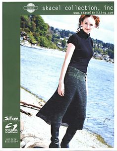 a woman in black shirt and skirt standing next to the water with her hands on her hips