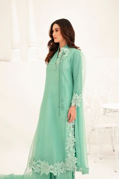 This light green Shalwar Kameez features a mint green organza lined shirt with lace appliqué all over the body and chaak, accompanied by a matching organza cutwork dupatta. The delicate lace adds an elegant touch to the traditional style, making this outfit perfect for any formal occasion. 3-Piece Suit Semi-stitched Green Organza Kurta, Unstitched Green Organza Kurta, Green Organza Dupatta For Formal Occasions, Green Organza Salwar Kameez For Eid, Traditional Salwar Kameez With Lace Work For Formal Occasions, Traditional Salwar Kameez With Lace Work For Formal Events, Traditional Lace Work Salwar Kameez For Formal, Green Anarkali Organza Kurta, Green Anarkali Kurta In Organza