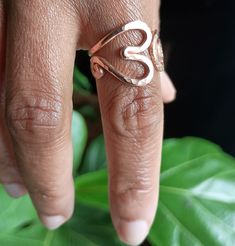 This is a thick gauge slightly adjustable ring designed so that it can be slightly pulled open to get over larger knuckles ,then pressed back closed.  This is a thicker gauge metal and can be requested in a thinner gauge which makes it even easier to open.  Enjoy the subtle caress of warm hand hammered copper gently snuggling your finger.  This is a very well rounded ring which fits the contour of your finger.  Even the edges of the spiral are hand hammered and rounded using an iron ring mandrel Adjustable Metal Heart Ring For Valentine's Day, Adjustable Heart-shaped Metal Ring, Adjustable Minimalist Heart Ring For Promise, Adjustable Metal Midi Rings With Open Band, Adjustable Open Ring Midi Rings As Gift, Adjustable Rose Gold Midi Rings For Promise, Adjustable Gold Midi Rings For Valentine's Day, Adjustable Metal Midi Rings For Gifts, Adjustable Metal Midi Rings As Gift