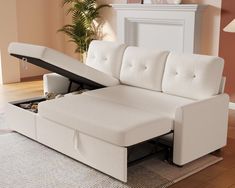 a white couch with a pull out bed underneath it