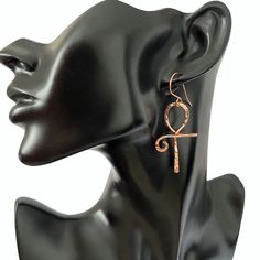 This pair of ankh earrings are lovely and symbolic. The ankh is an ancient Egyptian symbol which is also known as the key to the Nile and the key to life.  To make these earrings I formed  pure copper into the ankh shape and then lightly hammered the copper resulting in a beautiful texture which resembles diamond cuts.  To keep the copper tarnish free I coat the earrings with a tarnish resistant jewelry  protector. These earrings measures approximately 2 1/2 inches in length and 1 inch at widest point. Your earrings will arrive ready for gift giving in an organza gift bag or a cotton filled gift box  💝 Ankh-shaped Metal Earrings For Gift, Ankh Shaped Metal Earrings For Gift, Handmade Symbolic Ankh Earrings, Wind Jewelry, Aluminum Wire Jewelry, Hoop Earrings Diy, The Ankh, Ancient Egyptian Jewelry, Wire Jewelry Earrings