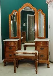 an antique dresser and mirror in a room