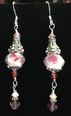 Absolutely stunning pink Swarovski crystal earrings.  The ear wires are sterling and the earrings also have pewter and more sterling. They are almost 2 1/2 inches long but are very lightweight. Silver Crystal Earrings With French Hook For Gifts, Elegant Earrings With French Hook And Czech Glass, Elegant Czech Glass Earrings With French Hook, Silver Czech Glass Crystal Earrings With Ear Wire, Pink Sterling Silver Crystal Earrings Nickel Free, Pink Beaded Crystal Drop Earrings, Pink Sterling Silver Wire Wrapped Earrings, Pink Sterling Silver Crystal Earrings As Gift, Sterling Silver Pink Wire Wrapped Earrings