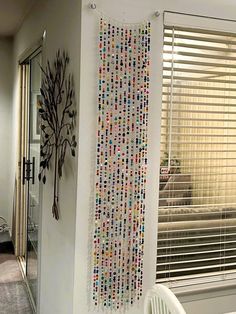 there is a wall decoration made out of beads and other things on the wall in this room