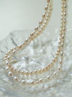 Product Information: Plating: White Gold Material: Freshwater Pearls (5-5.5mm) Size: Necklace Length 37-44 cm Weight: 28.5g Description: Elevate your style with our "Pulldown Double-Layer Beaded Pearl Necklace." This exquisite necklace features high-quality freshwater pearls, each measuring 5-5.5mm, and is elegantly plated with white gold. With an adjustable necklace length of 37-44 cm, it provides versatility in styling and ensures a perfect fit for any occasion. The double-layer design with de Classic Multi-strand Pearl Necklace For Wedding, Elegant Double Strand Pearl Necklace For Layering, Elegant Pearl Necklace For Layering With Round Beads, Elegant Pearl Necklace For Layering, Classic Pearl Necklace For Layering, Multi-strand Pearl Necklace For Layering, Classic Layering Pearl Necklace, Double Strand Pearl Chain Beaded Necklaces For Layering, Classic Multi-strand Pearl Necklace With Charm