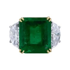 Features a color-rich emerald cut green emerald flanked by two brilliant half-moon diamonds. Set in a delicate and thin 18k yellow gold and platinum mounting. Green Emerald weighs 11.57 carats and is of Colombian origin. Size 6 US. Dimensions: 1.39 cm (L) x 2.15cm (W) Emerald Statement Ring, Colombian Emerald Ring, Triangle Diamond, Platinum Diamond Rings, Emerald Diamond Ring, Colombian Emeralds, Green Jewelry, Diamond Cocktail Rings, Emerald Engagement