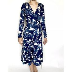 This Beautiful Yumi Kim Dress Is Perfect For Any Occasion, Whether It's A Formal Event Or A Casual Day Out. The Dress Features A Stunning Floral Pattern In Shades Of Navy Blue, With A V-Neckline And Long Sleeves. The Wrap Dress Style Adds A Touch Of Elegance, While The Tie Closure Ensures A Perfect Fit. New Measurements Laying Flat Pit To Pit 18" Length 44" Chic Blue Floral Print Wrap Dress, Blue Floral Print Maxi Wrap Dress, Blue Wrap Dress For Spring, Blue Midi Length Wrap Dress For Summer, Spring Blue Knee-length Wrap Dress, Blue Knee-length Wrap Dress For Spring, Blue Maxi Length Wrap Dress For Spring, Elegant Fitted Blue Wrap Dress, Blue Floral Print V-neck Wrap Dress