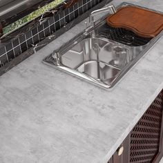 a stainless steel sink and counter top in a kitchen