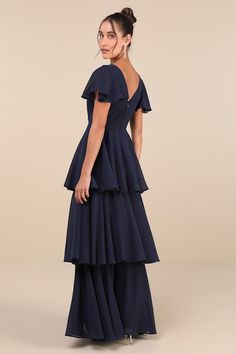 We know that some of your favorite memories will be made while wearing the Lulus Sincerely Exquisite Navy Blue Short Sleeve Tiered Maxi Dress! This timeless dress has an airy woven chiffon composition that shapes a lightly gathered bodice with a surplice neckline and V-back, framed by fluttery short sleeves. The high, fitted waist tops a flowy, tiered A-line skirt that falls to an elegant maxi hem. Hidden back zipper/clasp. Fit: This garment fits true to size. Length: Floor length. Size medium m Blue Georgette Dresses With Ruffles, Blue Chiffon Maxi Dress For Wedding Guest, Blue Ruffled Maxi Chiffon Dress, Blue A-line Chiffon Maxi Dress, Tiered Chiffon Evening Dress, Blue Flowy Chiffon Dress, Flowy Blue Georgette Maxi Dress, Blue Flowy A-line Chiffon Dress, Blue Flowy Maxi Dress For Wedding Guest