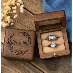 an engagement ring in a wooden box with the words mr and mrs engraved on it