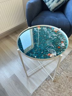 a blue chair sitting next to a glass table