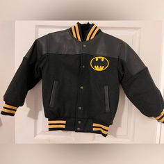 Brand New! Custom Made Jacket, Would Fit A Child Appx 4 Years Old To Probably 8 Years Old. Black And Yellow Varsity Letterman Jacket With Batman On The Back, Dark Charcoal Colored Sleeves Hooded Winter Outerwear With Character Print, Winter Hooded Outerwear With Character Print, Hooded Character Print Fall Outerwear, Pop Culture Long Sleeve Outerwear For Streetwear, Streetwear Long Sleeve Outerwear With Character Print, Streetwear Outerwear With Character Print, Long-sleeve Character Print Streetwear Outerwear, Winter Cartoon Print Outerwear For Streetwear, Casual Fall Outerwear With Character Print