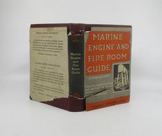 an old book is opened to show the front and back pages, with information about marine engine and fire room guide