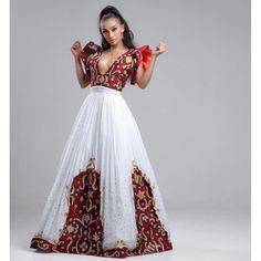 This stunning Habesha Kemis is a true masterpiece of Ethiopian fashion. The luxurious Menen fabric drapes elegantly over the body, creating a flattering silhouette. The upper portion of the dress features a Shimena top, which is a traditional Ethiopian blouse with a loose, flowing fit. The Shimena top adds a touch of elegance and sophistication to the dress. The lower portion of the dress features a Tilf design at the bottom, which is a traditional Ethiopian pattern that is often used in Habesha Ethiopian Pattern, Ethiopian Fashion, African Beaded Bracelets, Eritrean Dress, Ethiopian Clothing, Habesha Dress, Ethiopian Traditional Dress, Ethiopian Dress, Habesha Kemis