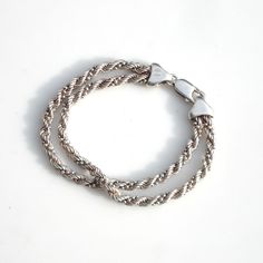 Wonderful double-stranded sterling silver bracelet - the links are twisted into a spiral. Stamped Milor, 925 and Italy. Measures 7 1/2 inches long. Width (both strands together) is 3/8 of an inch. Circa 1980. Sturdy construction with a large lobster claw clasp that closes securely. Weight is 16.4 grams or .58 oz. Excellent vintage condition with minor surface wear and some patina. Everyday Silver Jubilee Braided Bracelet, Silver Double Band Jewelry With Modern Twist, Modern Twist Silver Double Band Jewelry, Silver Sterling Silver Braided Jubilee Bracelet, Silver Bracelet With Polished Finish And Modern Twist, Silver Bracelets With Polished Finish And Modern Twist, Silver Bracelets With A Modern Twist, Sterling Silver Bracelet With A Modern Twist, Elegant Twisted Silver Bracelets