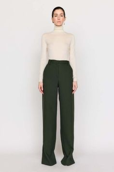 A timeless bootcut silhouette our cora pant is made from our italian twill suiting that’s blended with wool. this high-waist style features a front fly with zipper and a wide cuff at the hem. this classic forest hue invites neutrality and versatility to your wardrobe.    composition: wool twill  care: dry clean only  imported. Green Wide Leg Pants For Formal Fall Occasions, Formal Green Wide Leg Pants For Fall, Spring Wool Wide Leg Workwear Pants, Wool Wide Leg Pants For Workwear In Spring, Spring Wool Wide Leg Pants For Workwear, Fall Wide-leg Pantsuit For Workwear, Fall Wide Leg Dress Pants With Pressed Crease, Classic Wide-leg Fall Pantsuit, Classic Fall Pantsuit With Straight Pants