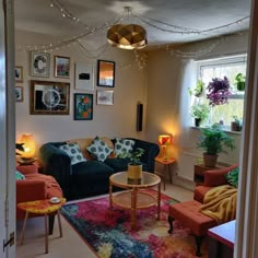 a living room filled with lots of furniture and pictures on the wall above it's windows