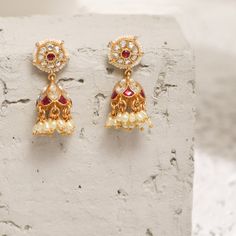 Description This timeless jhumki earring is perfectly crafted with polki stones on a gold-plated setting and finished with precious stones. An elegant wardrobe essential, these jhumki earrings will be your favorite. Style with the complementary accessories from the Vihara family for a grand look. This is the perfect choice for festival events and weddings. Product Information Materials used: 925 Silver with 1.0-microns Antique Gold Plating Stones: Semi precious stones Length: 3.5 cm Findings: Ho Luxury Fusion Style Jhumkas With Stone Work, Temple Jewelry Chandbali Earrings For Eid, Kundan Temple Jewelry Earrings For Reception, Bollywood Style Gold Plated Pearl Earrings For Festive, Temple Jewelry Kundan Earrings For Receptions, Stone Work Drop Jhumkas For Reception, Meenakari Earrings For Festive Reception, Stone Work Jhumkas For Reception, Gold Plated Tilla Jhumkas In Temple Jewelry Style